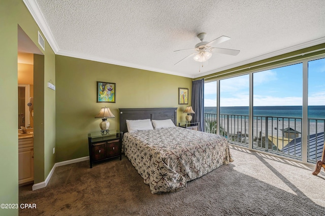 carpeted bedroom featuring ceiling fan, ornamental molding, a textured ceiling, access to exterior, and a water view