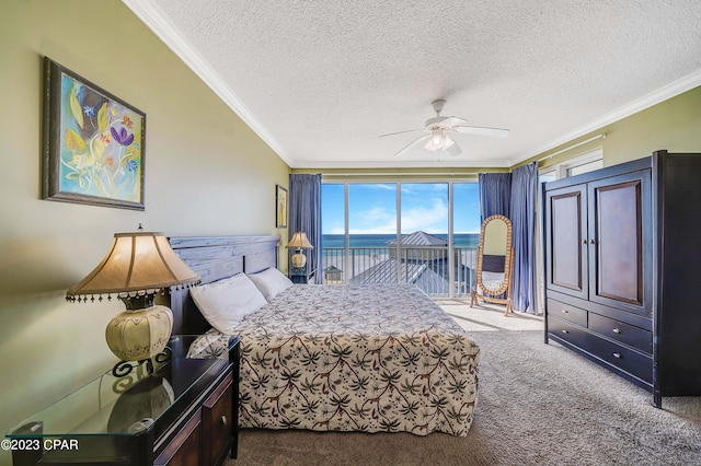 carpeted bedroom with a textured ceiling, access to exterior, a water view, crown molding, and ceiling fan