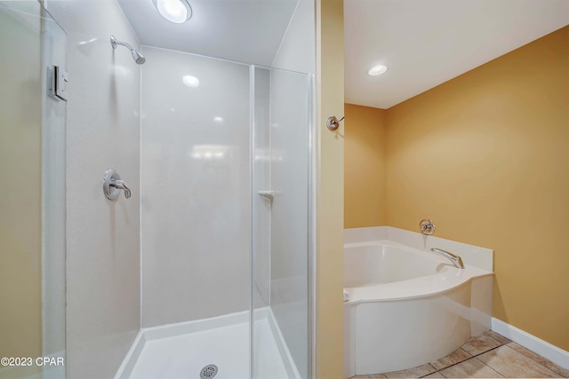 bathroom featuring independent shower and bath and tile patterned flooring