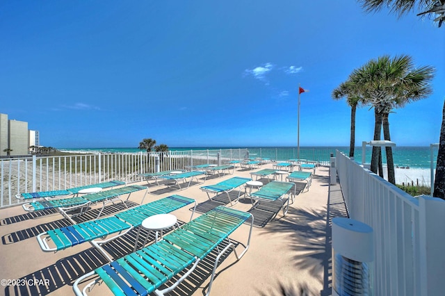 view of pool with a patio and a water view