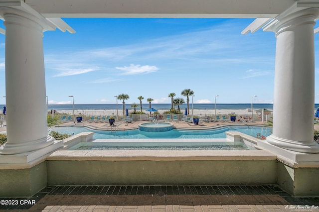 view of swimming pool featuring a water view and a patio area