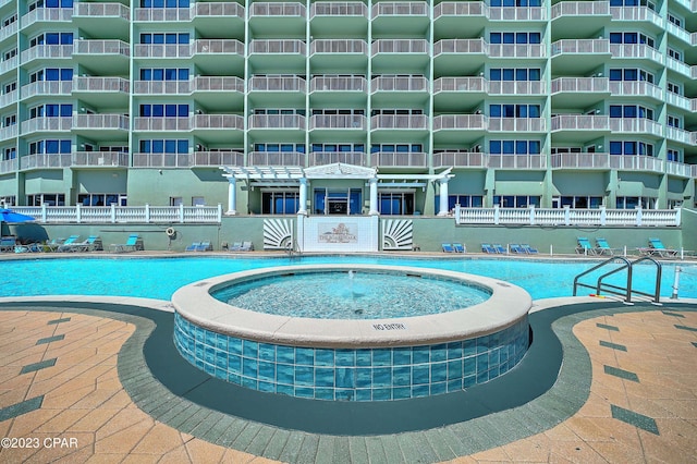 view of pool featuring a hot tub