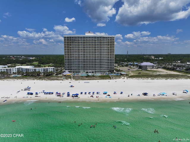 drone / aerial view featuring a water view and a view of the beach