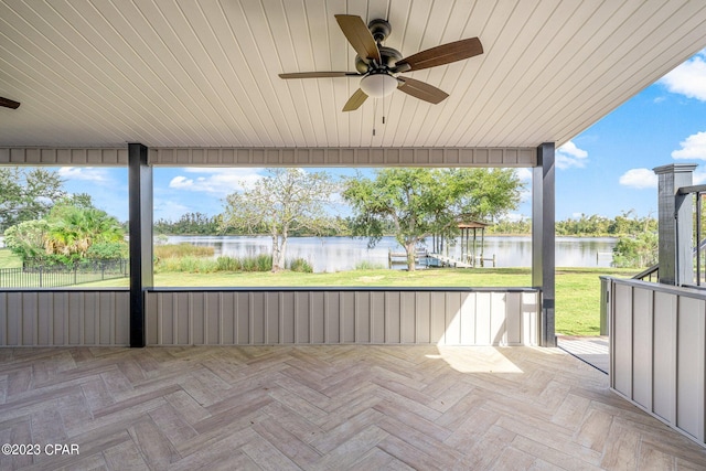 view of patio / terrace with a water view and ceiling fan