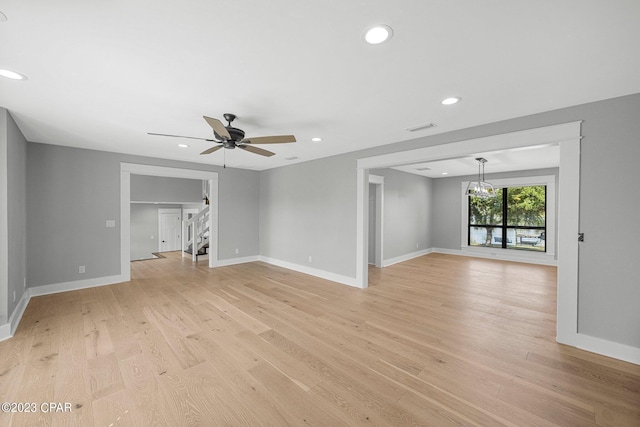 unfurnished living room featuring ceiling fan and light hardwood / wood-style flooring