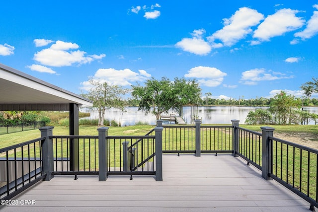 wooden terrace featuring a lawn and a water view