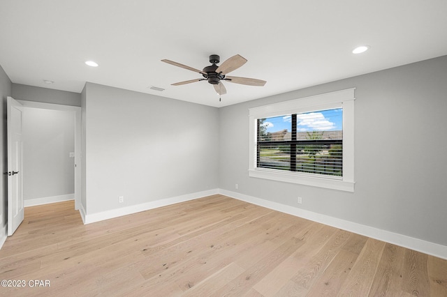 empty room featuring ceiling fan and light hardwood / wood-style floors