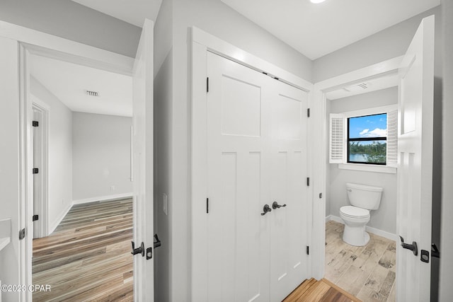 bathroom featuring hardwood / wood-style floors and toilet