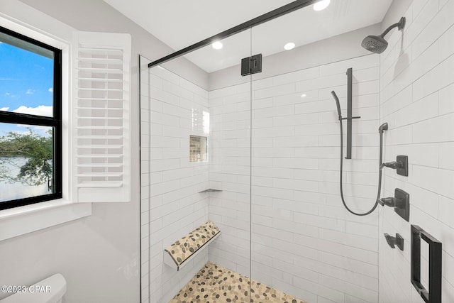 bathroom featuring toilet and walk in shower