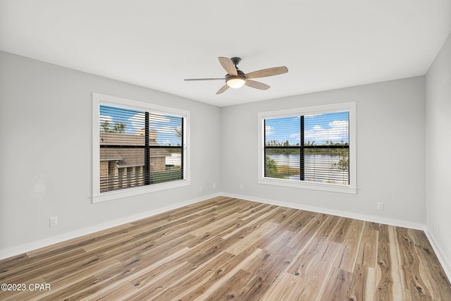 unfurnished room with light wood-type flooring, plenty of natural light, and ceiling fan