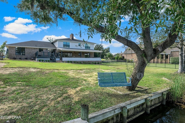 back of house featuring a sunroom and a yard