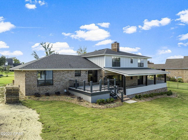 rear view of property with a yard