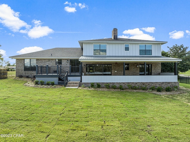 back of house featuring a lawn