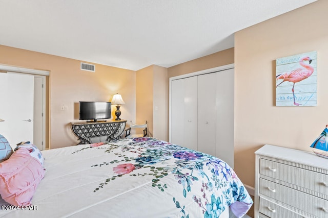 bedroom with a closet and visible vents