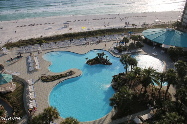 community pool featuring a patio area and a water view