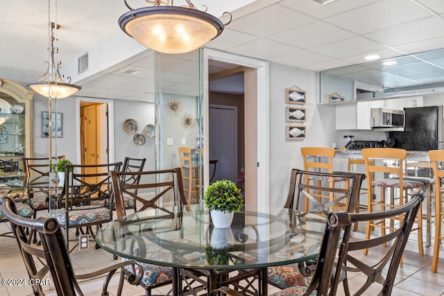 dining room featuring a drop ceiling and visible vents