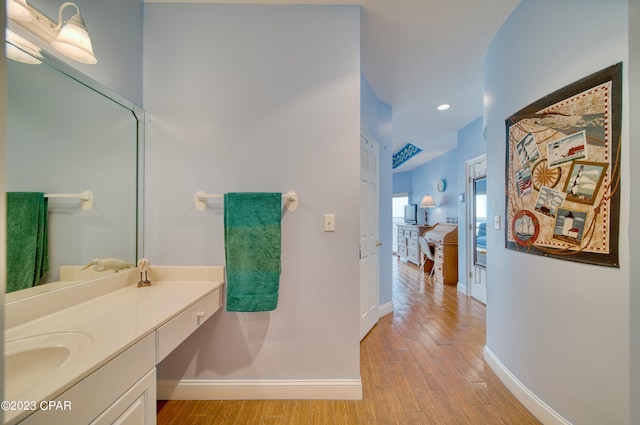 bathroom featuring wood-type flooring and vanity