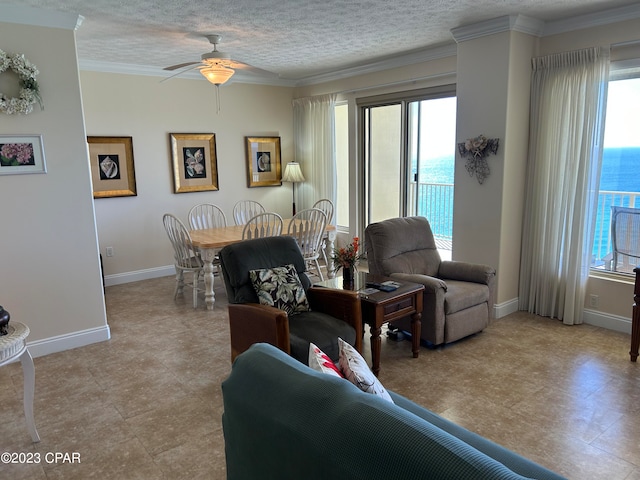 tiled living room with plenty of natural light, a textured ceiling, crown molding, and ceiling fan