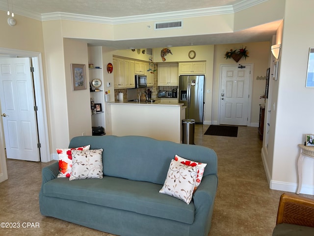 living room featuring crown molding and sink