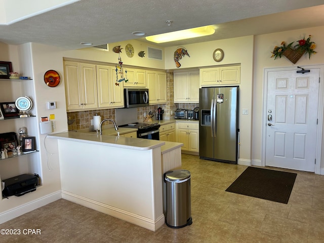 kitchen with appliances with stainless steel finishes, tasteful backsplash, kitchen peninsula, and light tile flooring