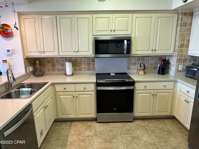 kitchen featuring light tile floors, tasteful backsplash, sink, and stainless steel appliances