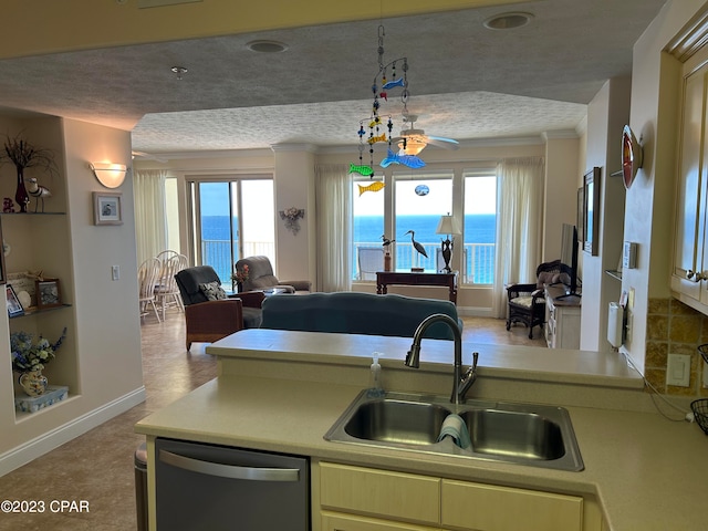 kitchen with stainless steel dishwasher, ceiling fan, a textured ceiling, a water view, and sink