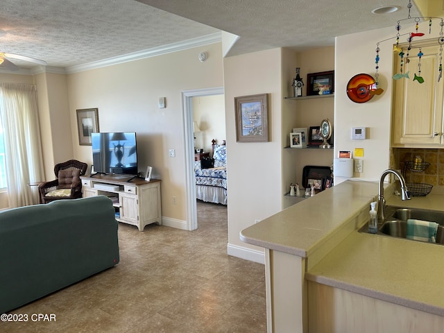 kitchen with light tile floors, a textured ceiling, ceiling fan, and sink