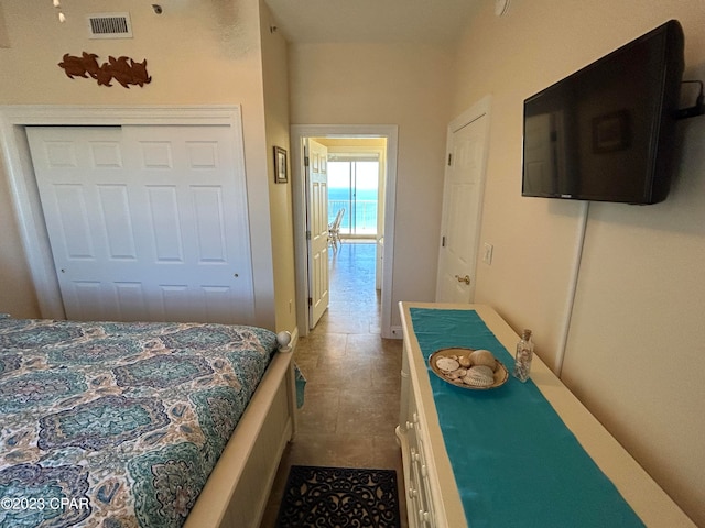 bedroom with a closet and light tile flooring