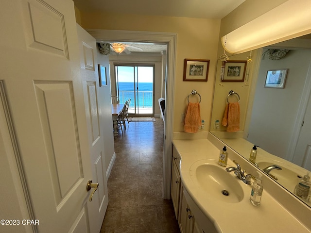 bathroom with tile floors, oversized vanity, and a water view