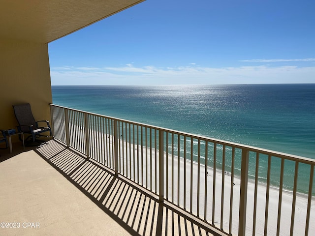 balcony with a beach view and a water view