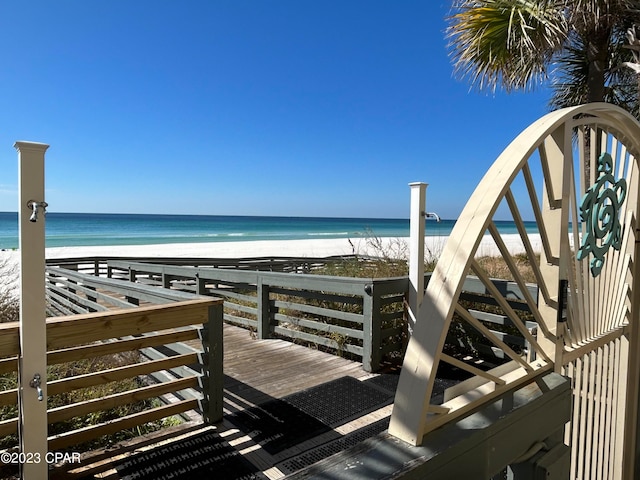 exterior space featuring a beach view and a water view