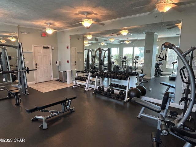 workout area with a textured ceiling, tile floors, and ceiling fan