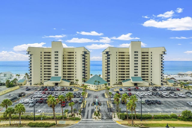 view of property featuring a water view and uncovered parking