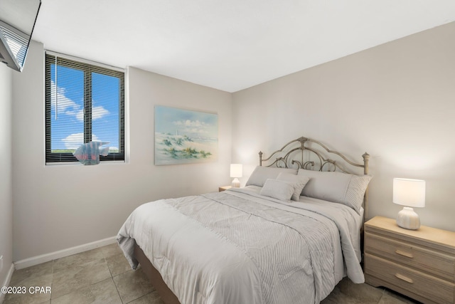 bedroom featuring tile patterned flooring and baseboards