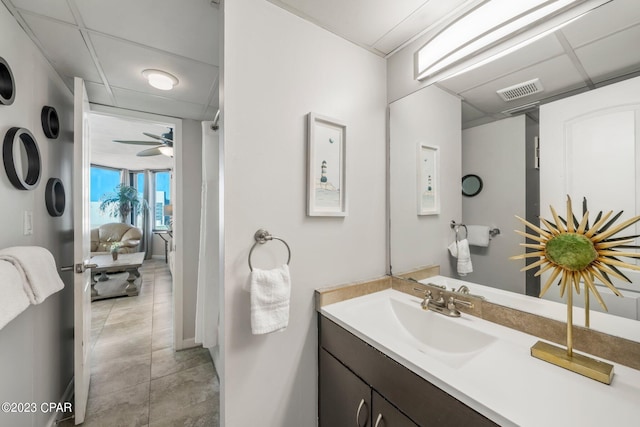 bathroom featuring visible vents, connected bathroom, vanity, a drop ceiling, and tile patterned floors