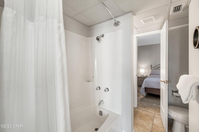 full bath featuring visible vents, shower / bath combo with shower curtain, a drop ceiling, and tile patterned floors