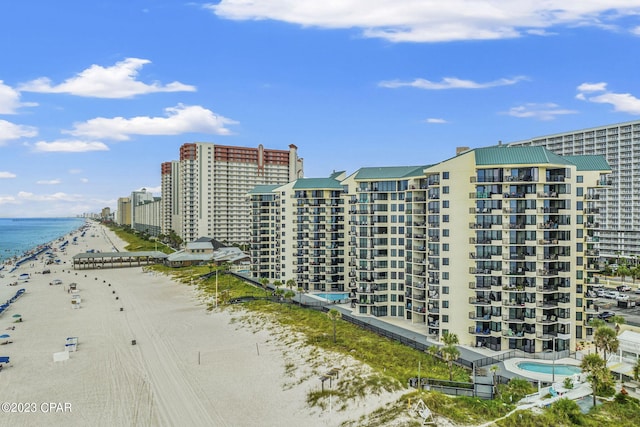 exterior space with a water view and a beach view