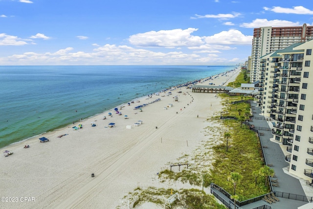 birds eye view of property with a water view and a beach view