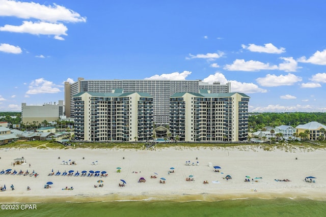 aerial view with a water view and a beach view