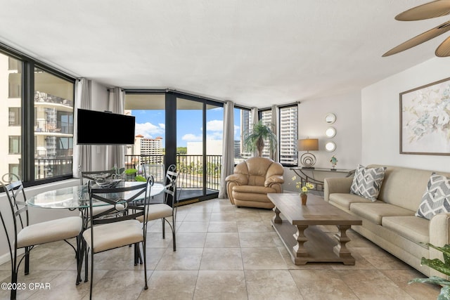 living room featuring expansive windows, ceiling fan, and tile patterned flooring