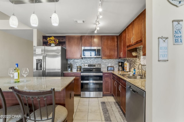 kitchen featuring visible vents, appliances with stainless steel finishes, tasteful backsplash, and a sink