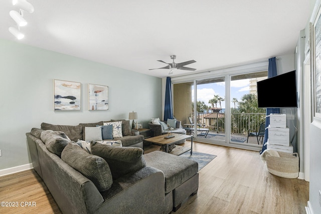 living room with hardwood / wood-style floors and ceiling fan