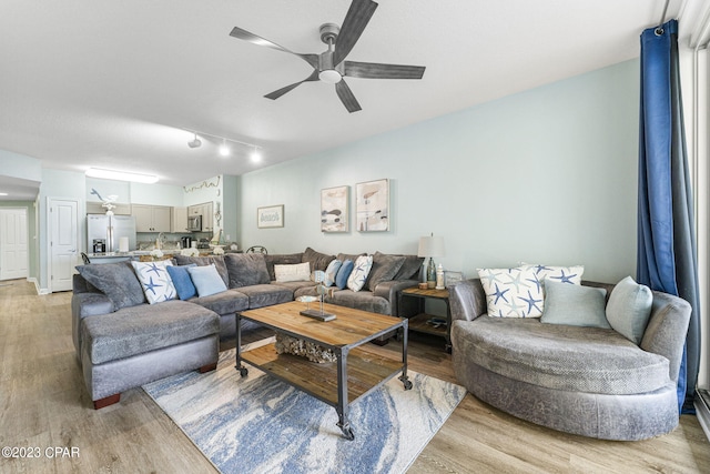 living room featuring ceiling fan, light wood-type flooring, and track lighting