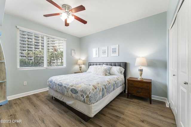 bedroom with hardwood / wood-style floors, ceiling fan, and a closet