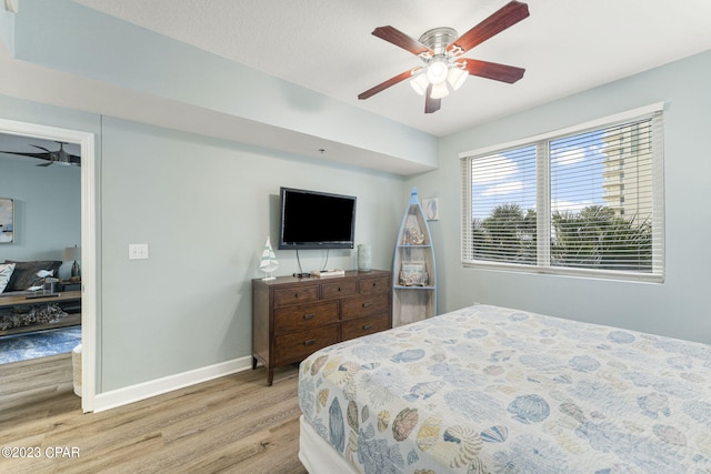 bedroom featuring ceiling fan and light wood-type flooring