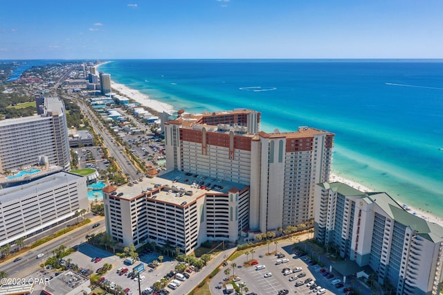 birds eye view of property with a water view and a beach view