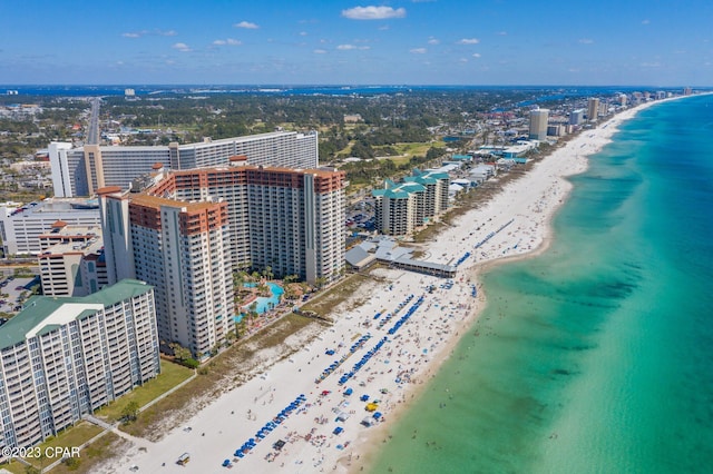 drone / aerial view featuring a water view and a beach view