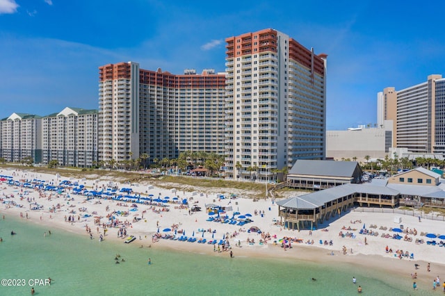 view of building exterior with a water view and a beach view