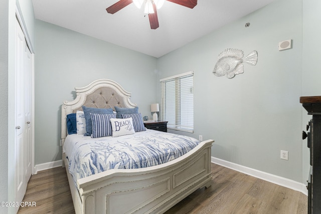 bedroom with a closet, ceiling fan, and dark hardwood / wood-style flooring