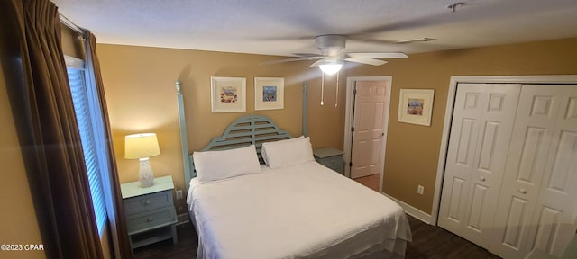 bedroom featuring dark hardwood / wood-style flooring, a closet, and ceiling fan